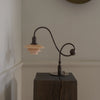 Modern Shop PH 1/1 piano table lamp featuring a sleek design with a black finish and adjustable shade for reading or decor.
