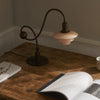 Modern black piano table lamp by The Modern Shop with a sleek, minimalist design and adjustable arm.