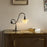 Modern Shop PH 1/1 piano table lamp with a sleek design and adjustable arm, perfect for reading or accent lighting.