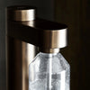 Stelton Brus Carbonator accessory with sleek design, used for carbonating beverages, in a modern minimalist style.