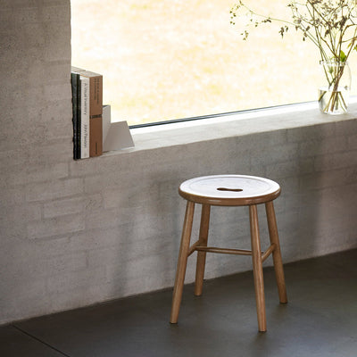 J27 stool by FDB Møbler featuring natural wood legs and a smooth wooden seat, showcasing classic Danish seating design.