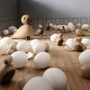 Kay Bojesen Songbird Collection for kids, featuring wooden bird figures with eggs, displayed on a floor.