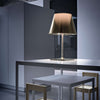 KTribe T2 lighting fixture by Flos, modern table lamp with sleek design and integrated LED light, placed on a wooden surface.