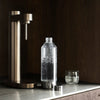 Stelton Brus Carbonator accessory with bronze metallic finish, designed for carbonation and beverage preparation.