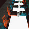 Lucy dining chair by Bend Goods in peacock blue and orange with a modern, curved metal design for stylish seating.