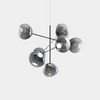 Large Melt Chandelier by Tom Dixon in polished nickel with smooth, sculptural design and polycarbonate elements for modern lighting.