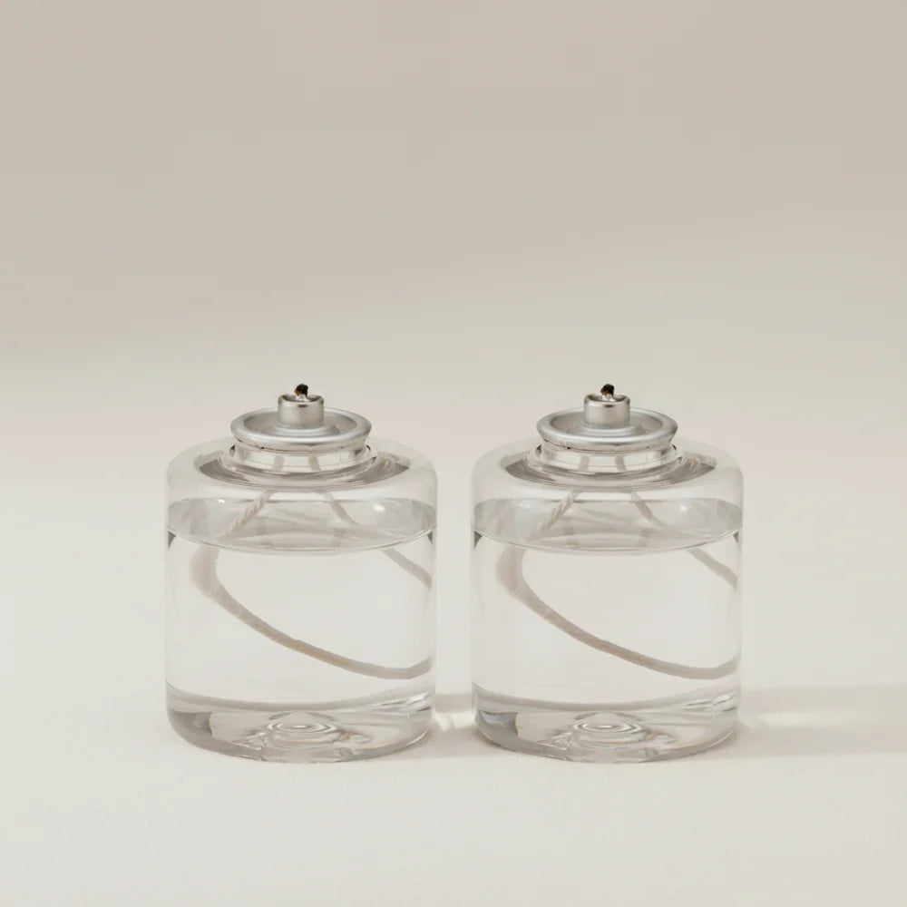 Set of two Rig-Tig Hygge Hurricane vegetable candle refills with natural vegetable-based wax in clear containers.