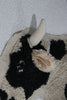 Kids' Lola the Cow Pouf by Lorena Canals featuring a soft, plush cow design perfect for children's room decor.