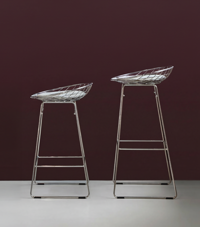 Pastoe KM06 Bar Stool Low, modern seating with wooden legs and upholstered seat, displayed in a contemporary interior setting