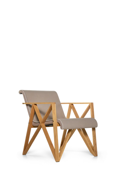 Pastoe Metz&Co armchair, modern seating with sleek design and plush upholstery, shown from a side angle.