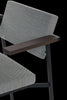 Dark brown oak armrest dining chair from Pastoe SE69 collection, showcasing sleek seating design with wooden accents.