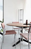 Black TE06 dining table by Pastoe with sleek metal legs, shown in a modern dining room setting.