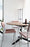 Black TE06 dining table by Pastoe with sleek metal legs, shown in a modern dining room setting.