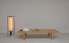 Pastoe BZ Bench, a modern wooden seating bench with a natural finish, shown in a spacious living room setting.