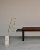 Black Pastoe BZ Bench seating with sleek wooden legs, designed for modern living spaces.