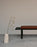 Black Pastoe BZ Bench seating with sleek wooden legs, designed for modern living spaces.