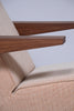Pastoe Press Room Chair with sleek serpentine design, showcasing smooth wooden armrests and ergonomic seating for modern interiors.
