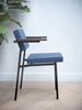 Blue SE69 dining chair by Pastoe with sleek modern design, featuring a curved backrest and wooden legs.
