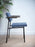 Blue SE69 dining chair by Pastoe with sleek modern design, featuring a curved backrest and wooden legs.