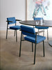 Pastoe SE69 dining chair with sleek wooden frame and upholstered seat, shown from a side angle in a modern dining setting.