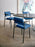 Pastoe SE69 dining chair with sleek wooden frame and upholstered seat, shown from a side angle in a modern dining setting.