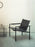 Pastoe SZ02 armchair with leather upholstery and wooden backrest, showcasing modern seating design and craftsmanship.