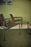 Pastoe SZ02 armchair with leather upholstery and wooden back frame, stylish seating piece for modern interior decor.