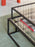 Black Tangled Coffee Table by Pastoe featuring a unique twisted design, made of sleek, modern tables for contemporary living spaces.