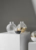 Skultuna Pomme small accessories in polished metal with smooth, rounded design on a plain background.