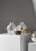 Skultuna Pomme small accessories in polished metal with smooth, rounded design on a plain background.