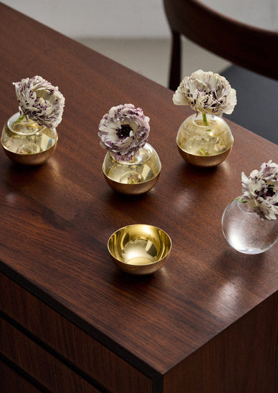 Skultuna Pomme accessories featuring a sleek, modern design with smooth curves and a polished metal finish.