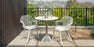 Bend Goods Rita Chair, modern seating with a sleek, curved metal frame and woven seat in a contemporary design.