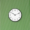 Arne Jacobsen Station wall clock with minimalist design, featuring a round face and sleek hands, mounted on a wall as a stylish accessory.