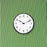 Arne Jacobsen Station wall clock with minimalist design, featuring a round face and sleek hands, mounted on a wall as a stylish accessory.