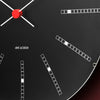 Arne Jacobsen Bankers Wall Clock with minimalist design and black hour markers on a white face, mounted on a plain wall.
