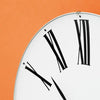 Roman Wall Clock by Arne Jacobsen, minimalist accessories with a sleek round face and Roman numeral markings, mounted on a wall.