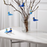 Two blue and light blue bird accessories by Kay Bojesen, 1.9-inch size, featuring detailed bird design on a neutral background.
