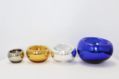 SkLo Echo Vessel accessory featuring a modern, sculptural glass design with smooth curves and transparent finish.