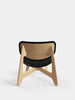 Slab Lounge Chair by Tom Dixon featuring natural brushed oak frame and black leather seat in a modern seating design