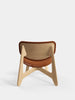 Natural brushed oak slab lounge chair with cognac leather upholstery by Tom Dixon, showcasing its modern seating design.