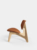 Slab Lounge Chair by Tom Dixon featuring natural brushed oak frame and cognac leather upholstery, modern seating design.