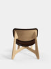 Tom Dixon Slab lounge chair with natural wood frame and brown leather upholstery, modern seating with sleek design.
