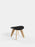 Tom Dixon Slab Ottoman with a natural brushed oak base and black leather top, used as stylish seating.