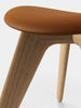 Tom Dixon Slab Ottoman with natural brushed oak base and cognac leather seating, modern and stylish seating furniture.