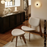 Natural Slab Ottoman by Tom Dixon with boucle upholstery, showcasing a modern seating piece in a neutral tone.