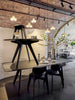 Small black round Slab table by Tom Dixon with a brushed oak surface, showcasing its modern, minimalist design.