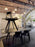 Small black round Slab table by Tom Dixon with a brushed oak surface, showcasing its modern, minimalist design.