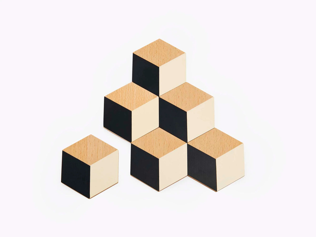 Areaware Table Tiles coasters in black and beige, featuring a modern geometric design on a white background.