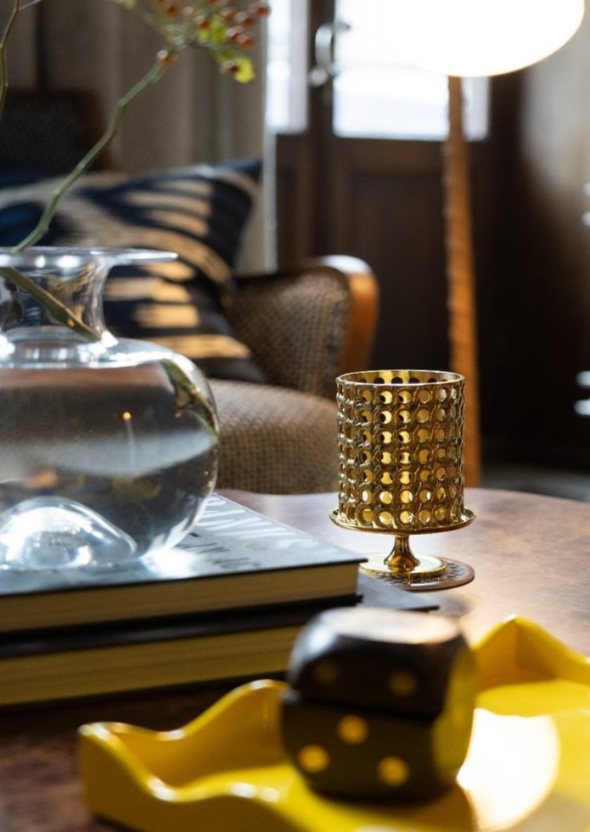 Skultuna Lantern accessory featuring a sleek, modern design with a metallic finish and a glass enclosure for candles.