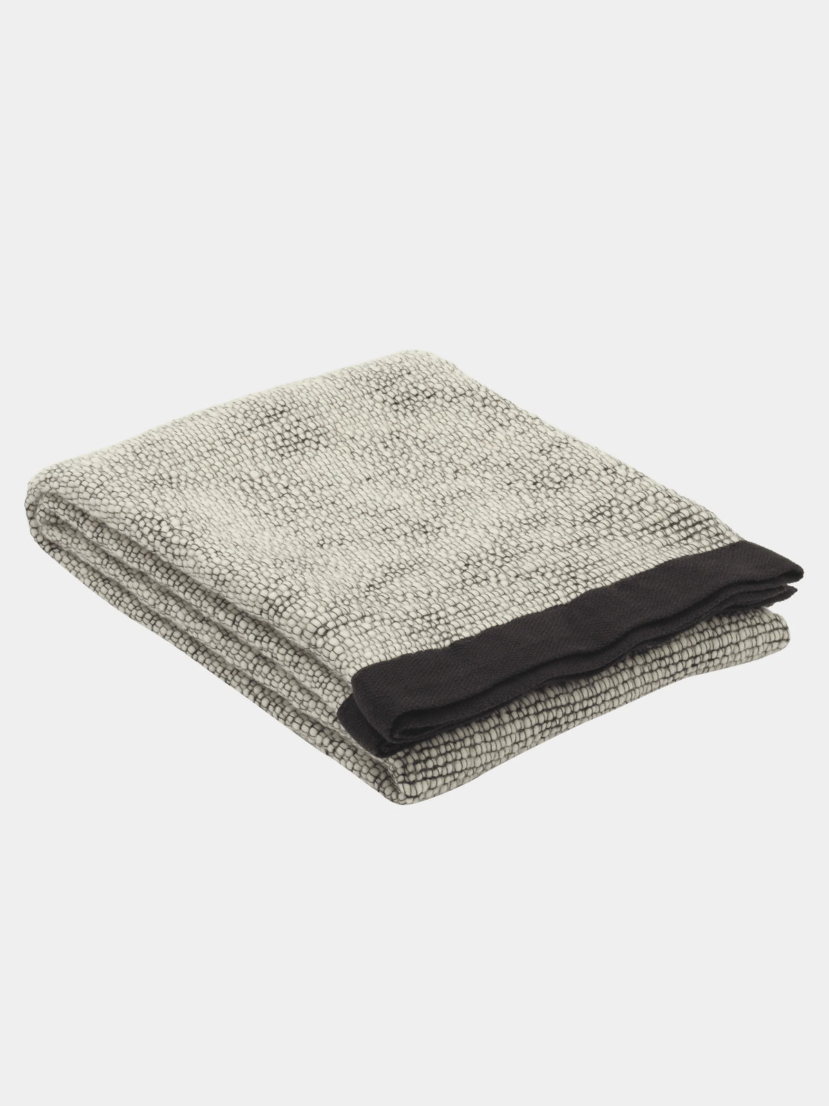 Black Thread Throw by Tom Dixon, a cozy woven accessories piece with intricate thread details and textured fabric.